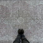 1970s pale red vintage turkish rug with neutral design, hand-knotted weave and low pile.