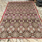 Pink 7' x 11' vintage turkish rug in wool and cotton, shown on the floor.