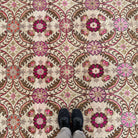 1970s pink vintage turkish rug with floral and geometric design, hand-knotted weave and low pile.