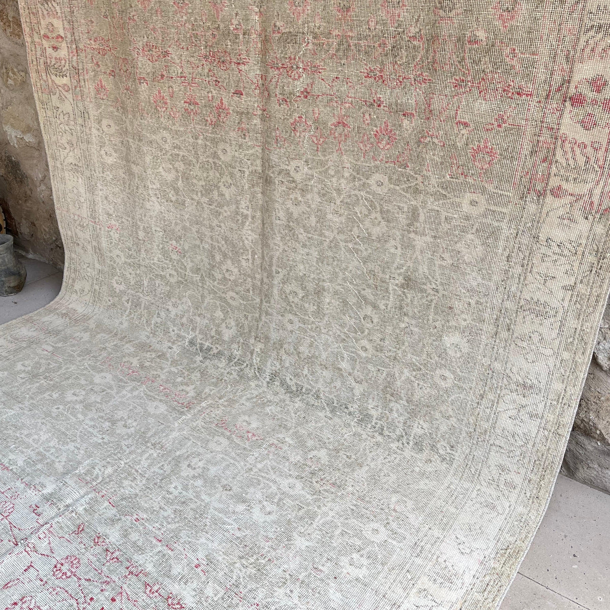 Beige 7' x 12' vintage turkish rug in wool and cotton, shown on the floor.