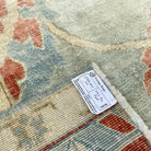 Close-up of the pale blue vintage turkish rug showing floral details, hand-knotted weave, wool and cotton and low pile.