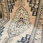 Blue 7' x 13' vintage turkish rug in wool and cotton, shown on the floor.