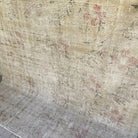 1970s beige vintage turkish rug with neutral design, hand-knotted weave and low pile.