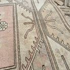 Close-up of the beige vintage turkish rug showing neutral details, hand-knotted weave, wool and cotton and low pile.