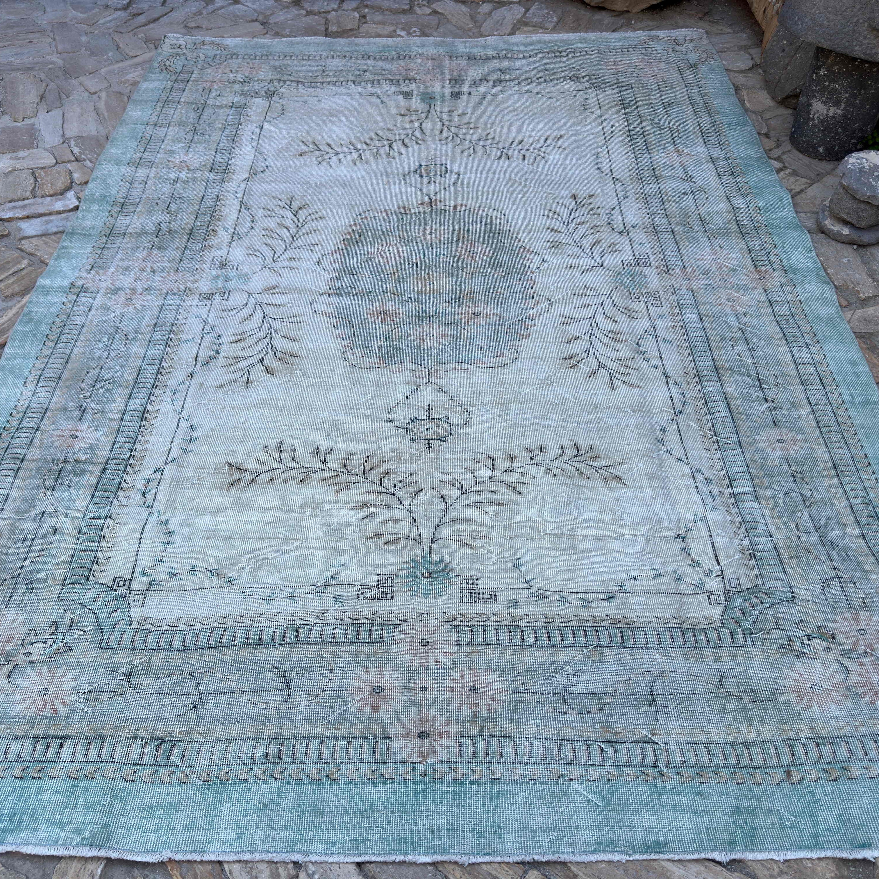 Green 8' x 11' vintage turkish rug in wool and cotton, shown on the floor.