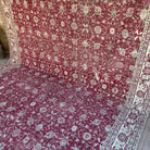 Red 8' x 12' vintage turkish rug in wool and cotton, shown on the floor.