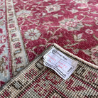 1970s red vintage turkish rug with floral design, hand-knotted weave and low pile.