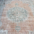 1970s orange vintage turkish rug with medallion design, hand-knotted weave and low pile.