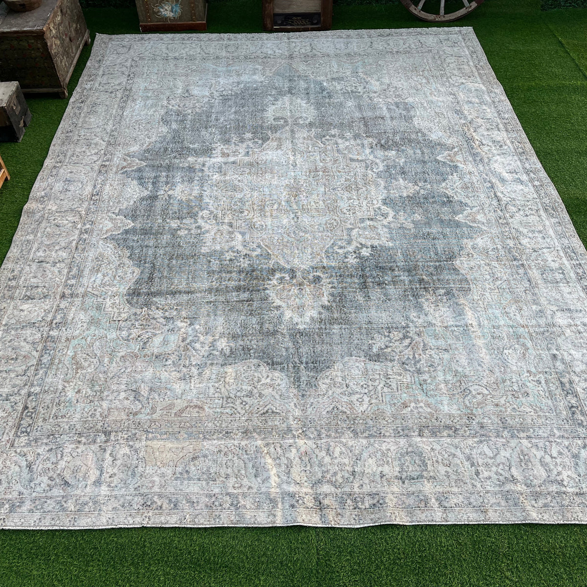 Beige 9' x 12' vintage turkish rug in wool and cotton, shown on the floor.