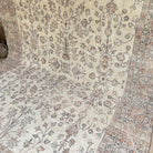 Pink 9' x 12' vintage turkish rug in wool and cotton, shown on the floor.