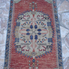 Close-up of the red vintage turkish rug, hand-knotted weave, wool and cotton and low pile.