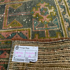 Close-up of the pink vintage turkish runner rug showing patchwork details, hand-knotted weave, wool and cotton and low pile.