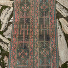 1970s pink vintage turkish runner rug with patchwork design, hand-knotted weave and low pile.