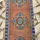 1970s orange vintage turkish runner rug with geometric design, hand-knotted weave and low pile.
