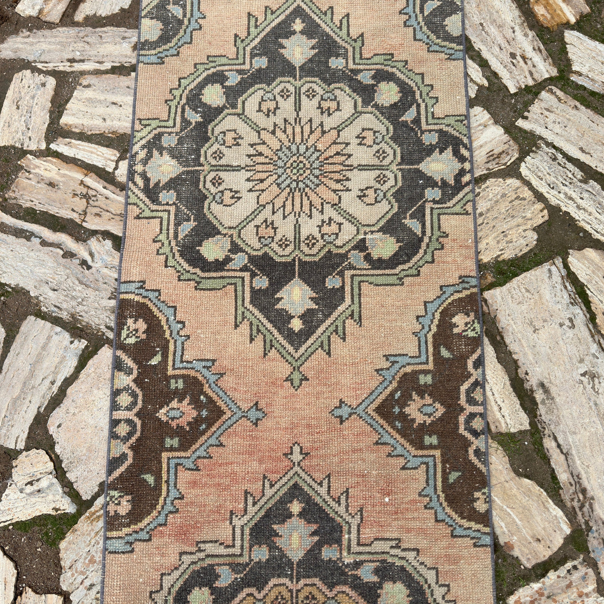 1970s pink vintage turkish runner rug with traditional design, hand-knotted weave and low pile.