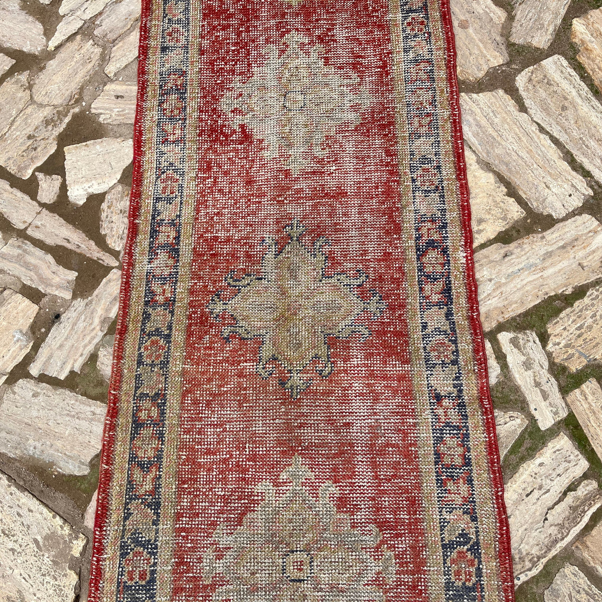 1970s red vintage turkish runner rug with geometric design, hand-knotted weave and low pile.