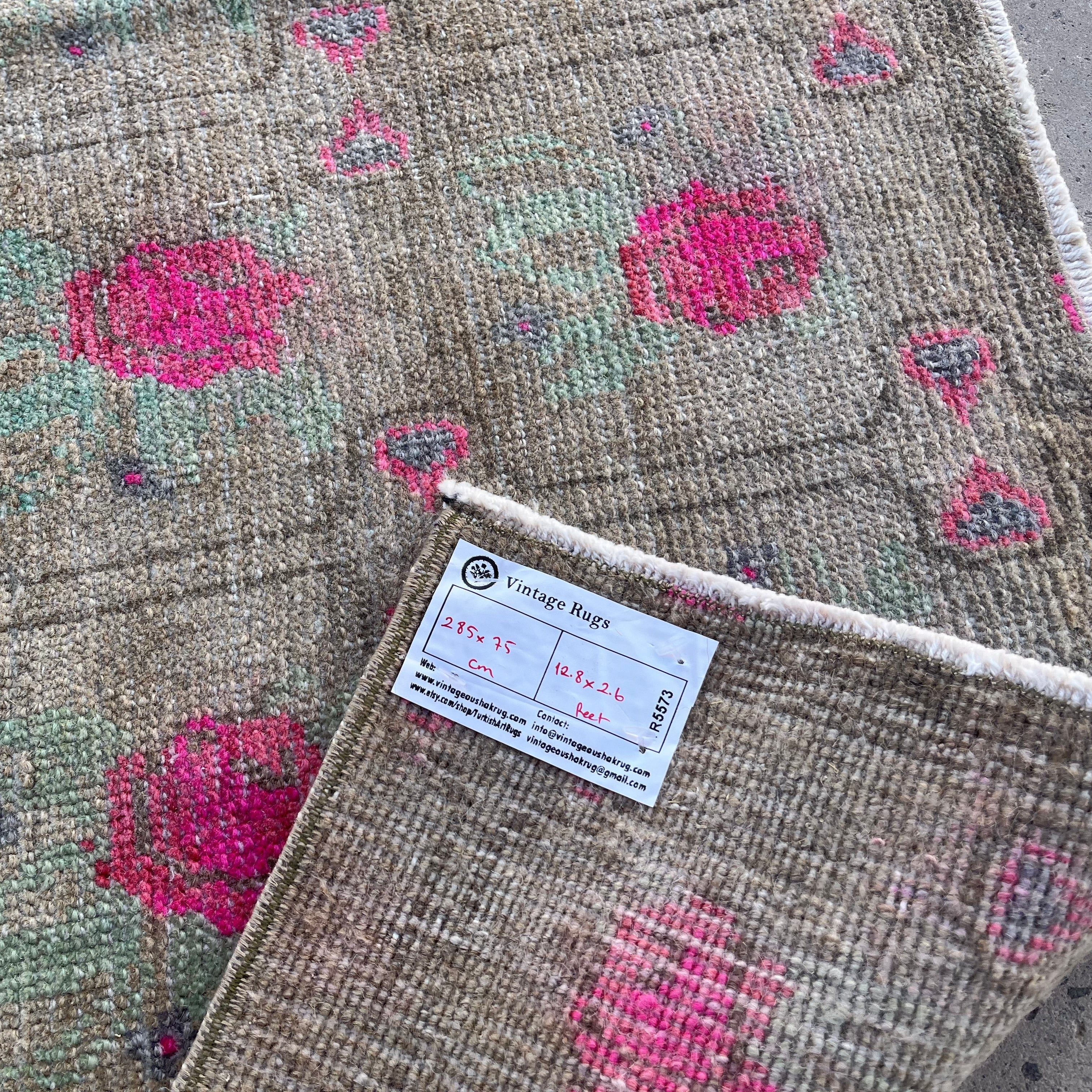 Close-up of the brown vintage turkish runner rug showing floral details, hand-knotted weave, wool and cotton and low pile.