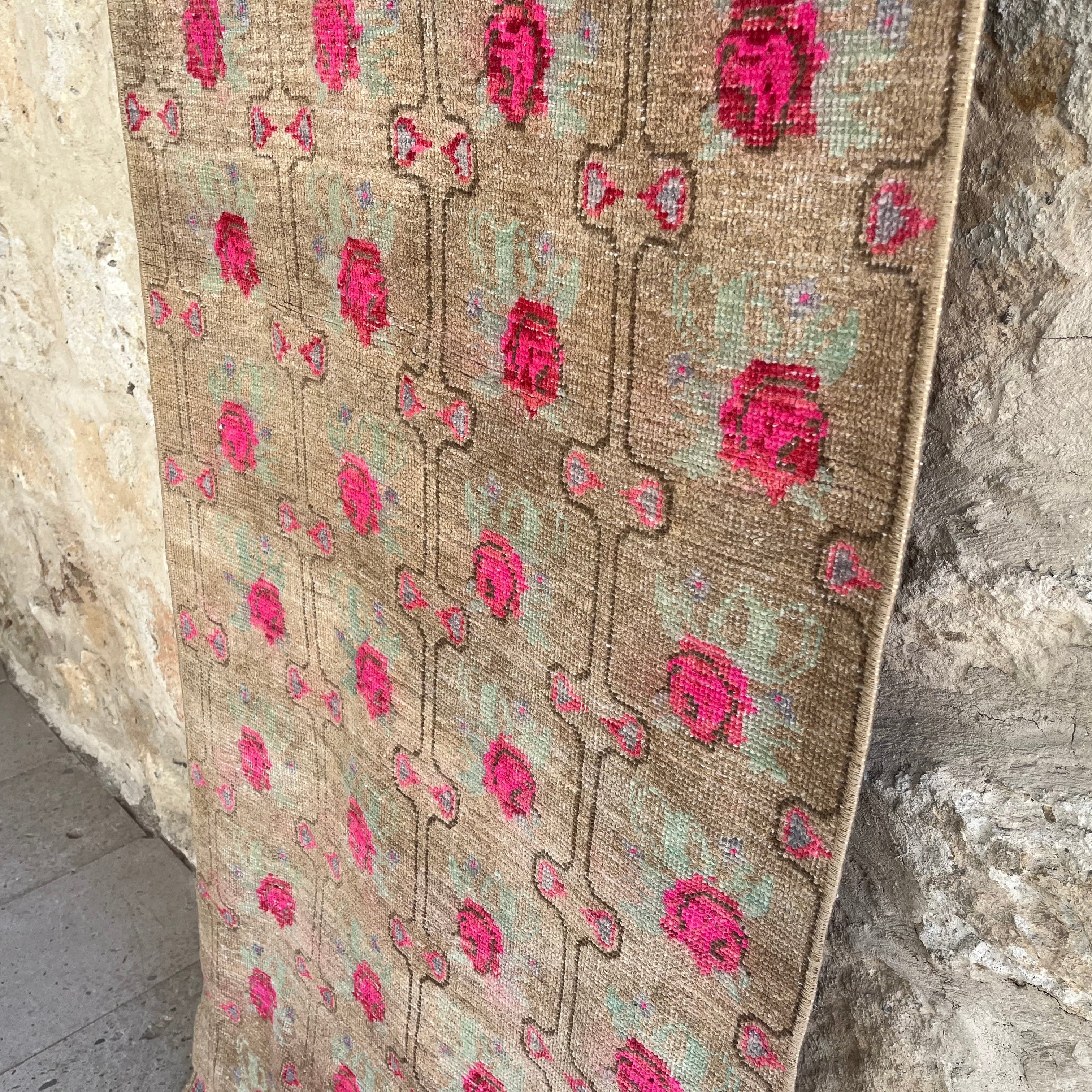 1970s brown vintage turkish runner rug with floral design, hand-knotted weave and low pile.