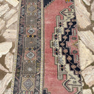 1970s pink vintage turkish runner rug with traditional design, hand-knotted weave and low pile.