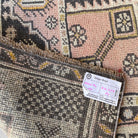 Close-up of the pink vintage turkish runner rug showing traditional details, hand-knotted weave, wool and cotton and low pile.