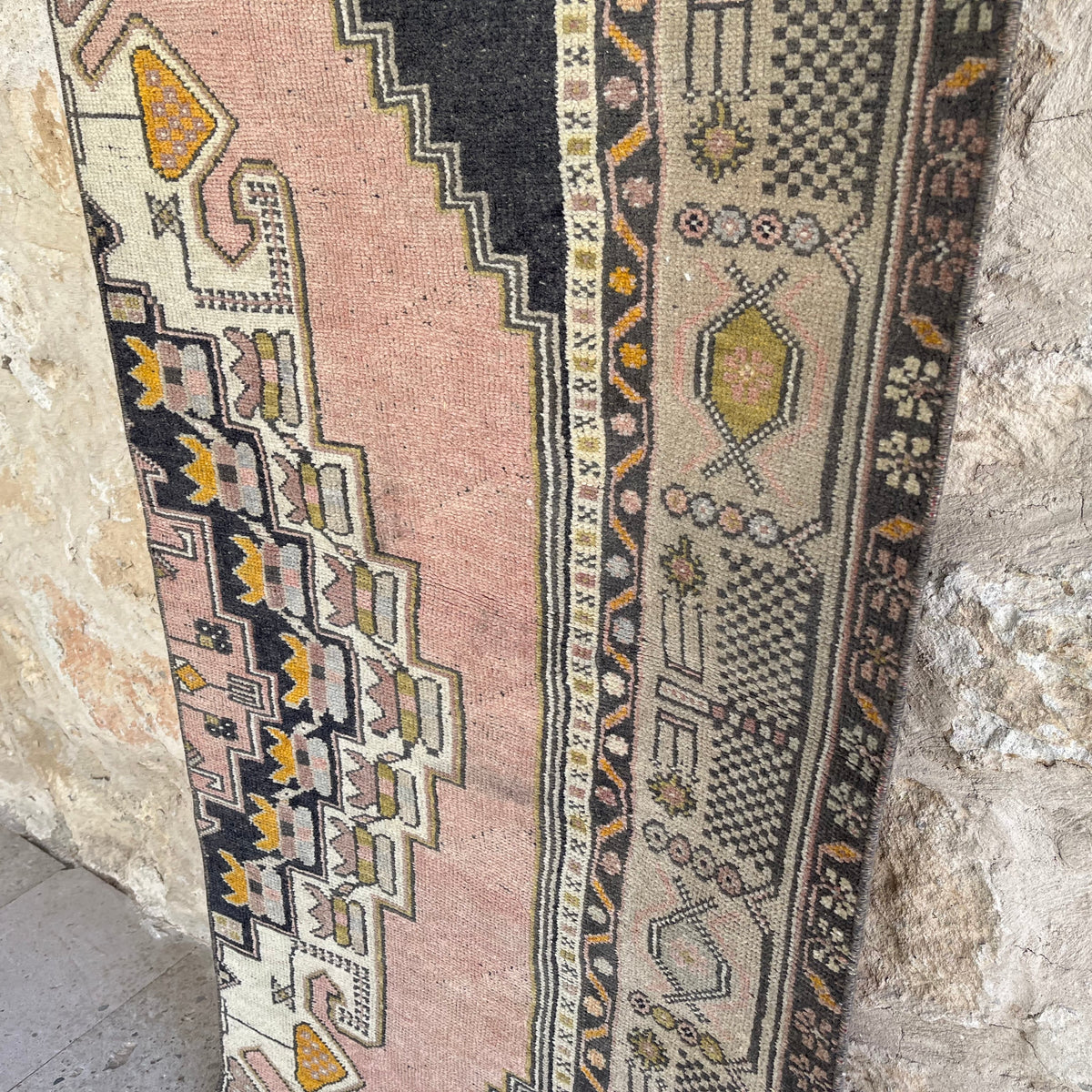 Pink 2' x 8' vintage turkish runner rug in wool and cotton, shown on the floor.