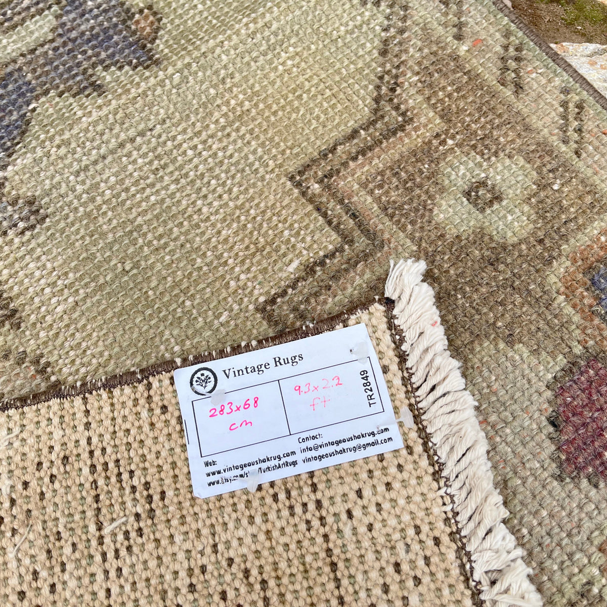 Close-up of the beige vintage turkish runner rug showing traditional details, hand-knotted weave, wool and cotton and low pile.