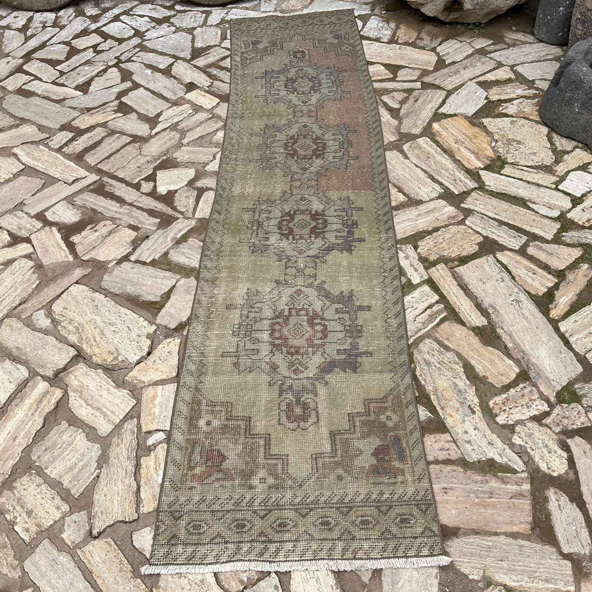 Beige 2' x 9' vintage turkish runner rug in wool and cotton, shown on the floor.