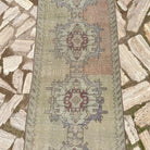 1970s beige vintage turkish runner rug with traditional design, hand-knotted weave and low pile.