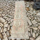 Pale Red 2' x 9' vintage turkish runner rug in wool and cotton, shown on the floor.