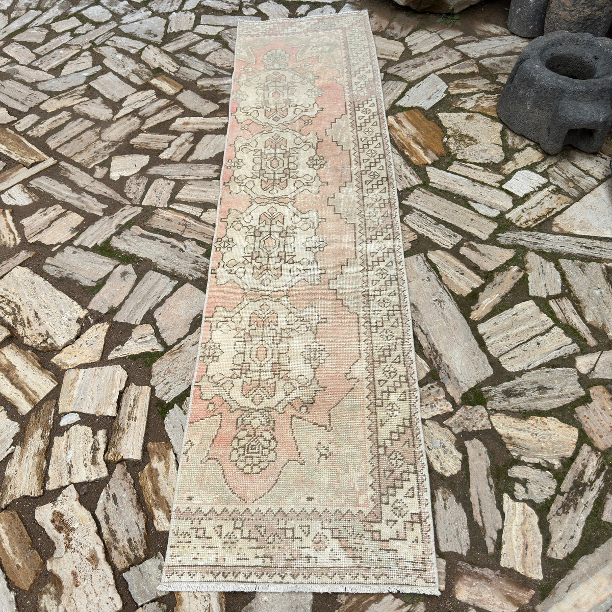 Pale Red 2' x 9' vintage turkish runner rug in wool and cotton, shown on the floor.