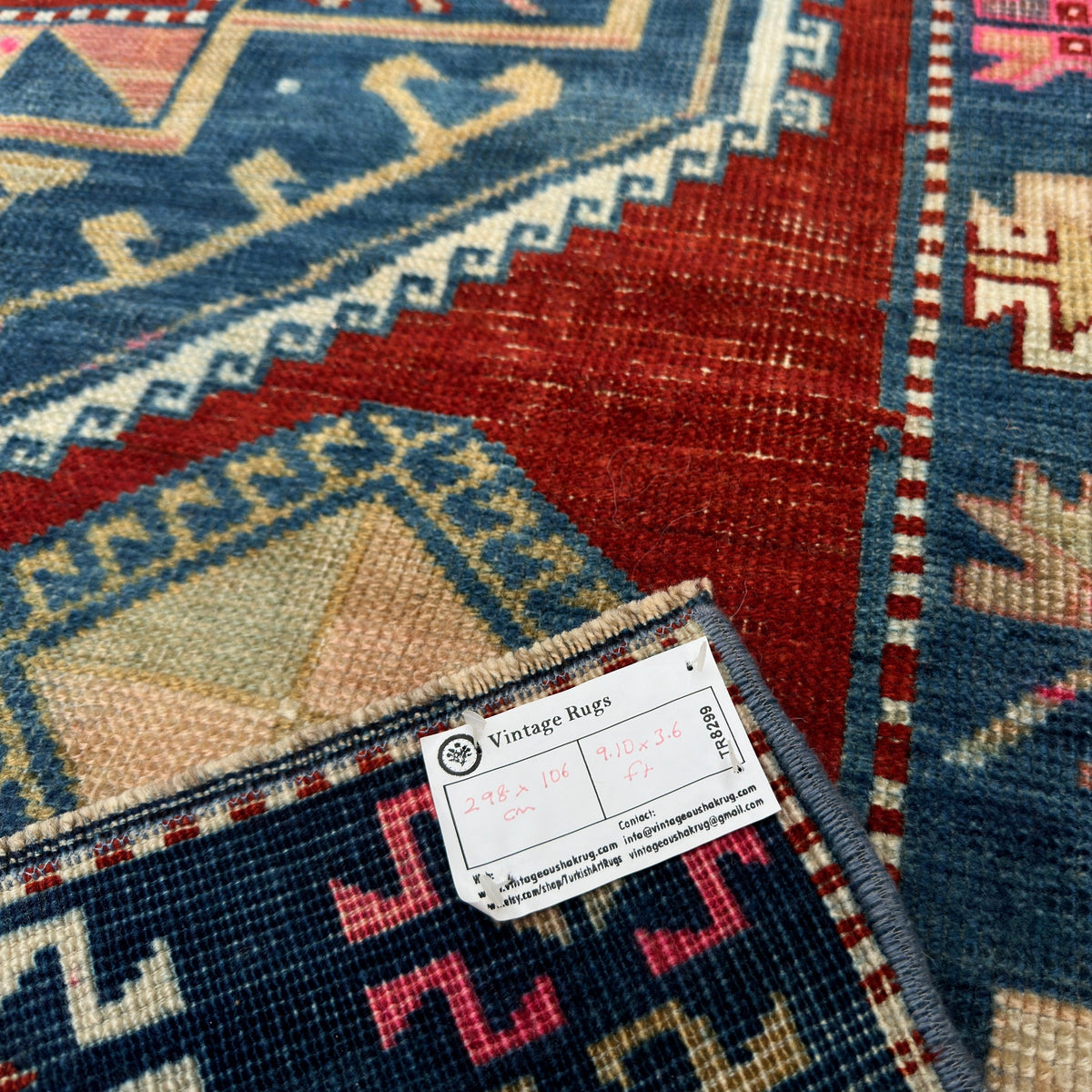 Close-up of the blue vintage turkish runner rug showing oushak details, hand-knotted weave, wool and cotton and low pile.