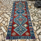 Blue 3' x 10' vintage turkish runner rug in wool and cotton, shown on the floor.