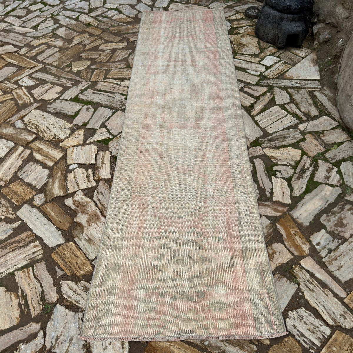 Pale Pink 3' x 10' vintage turkish runner rug in wool and cotton, shown on the floor.