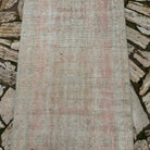 1970s pale pink vintage turkish runner rug with traditional design, hand-knotted weave and low pile.