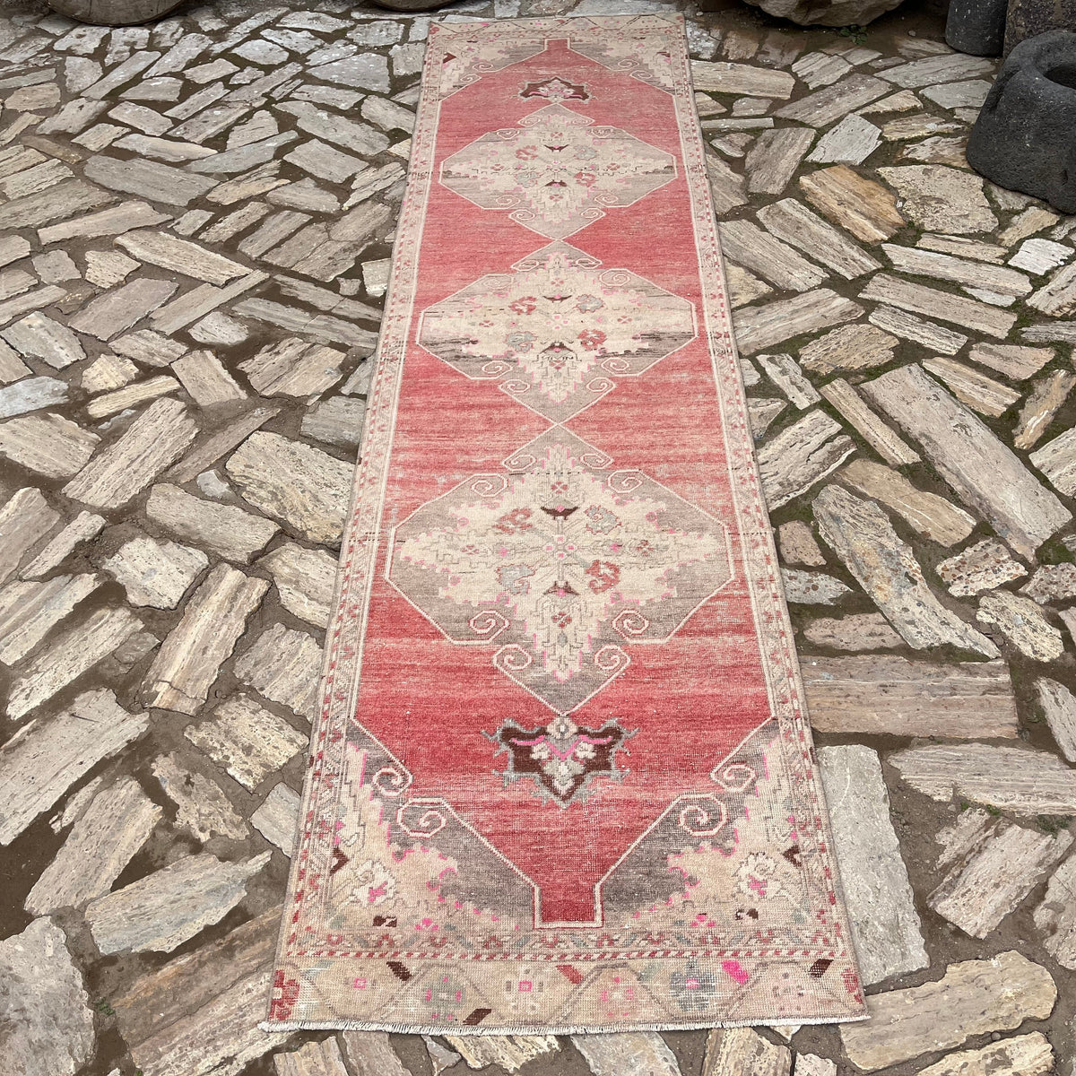 Pale Red 3' x 10' vintage turkish runner rug in wool and cotton, shown on the floor.
