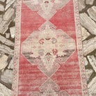 1970s pale red vintage turkish runner rug with traditional design, hand-knotted weave and low pile.