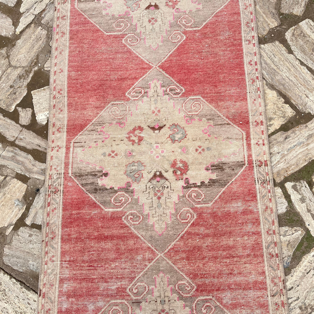 1970s pale red vintage turkish runner rug with traditional design, hand-knotted weave and low pile.