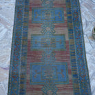 Close-up of the blue vintage turkish runner rug showing traditional details, hand-knotted weave, wool and cotton and low pile.