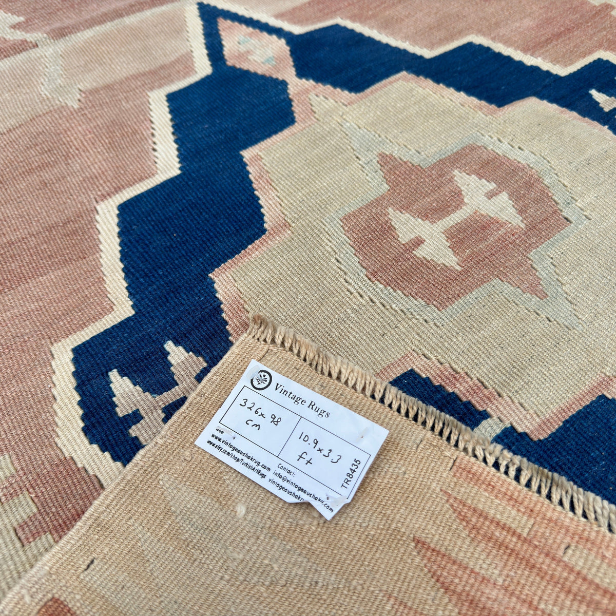 Close-up of the brown vintage turkish runner rug showing medallion details, hand-knotted weave, wool and cotton and low pile.
