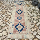 Brown 3' x 11' vintage turkish runner rug in wool and cotton, shown on the floor.