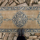 1970s pale yellow vintage turkish runner rug with medallion design, hand-knotted weave and low pile.