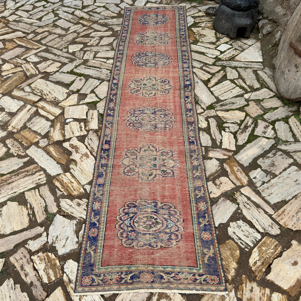 Red 3' x 11' vintage turkish runner rug in wool and cotton, shown on the floor.