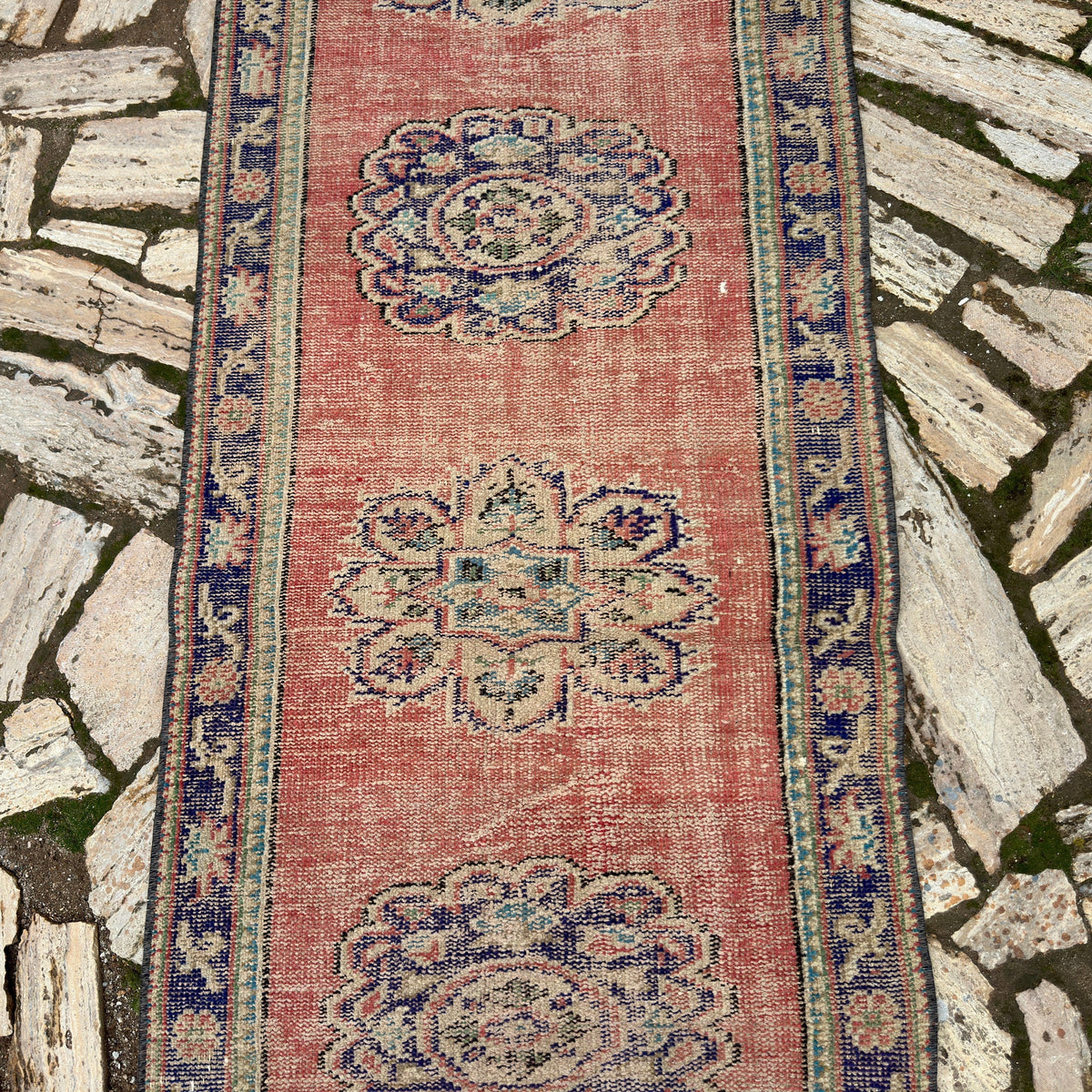 1970s red vintage turkish runner rug with traditional design, hand-knotted weave and low pile.