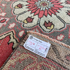 Close-up of the red vintage turkish runner rug showing traditional details, hand-knotted weave, wool and cotton and low pile.