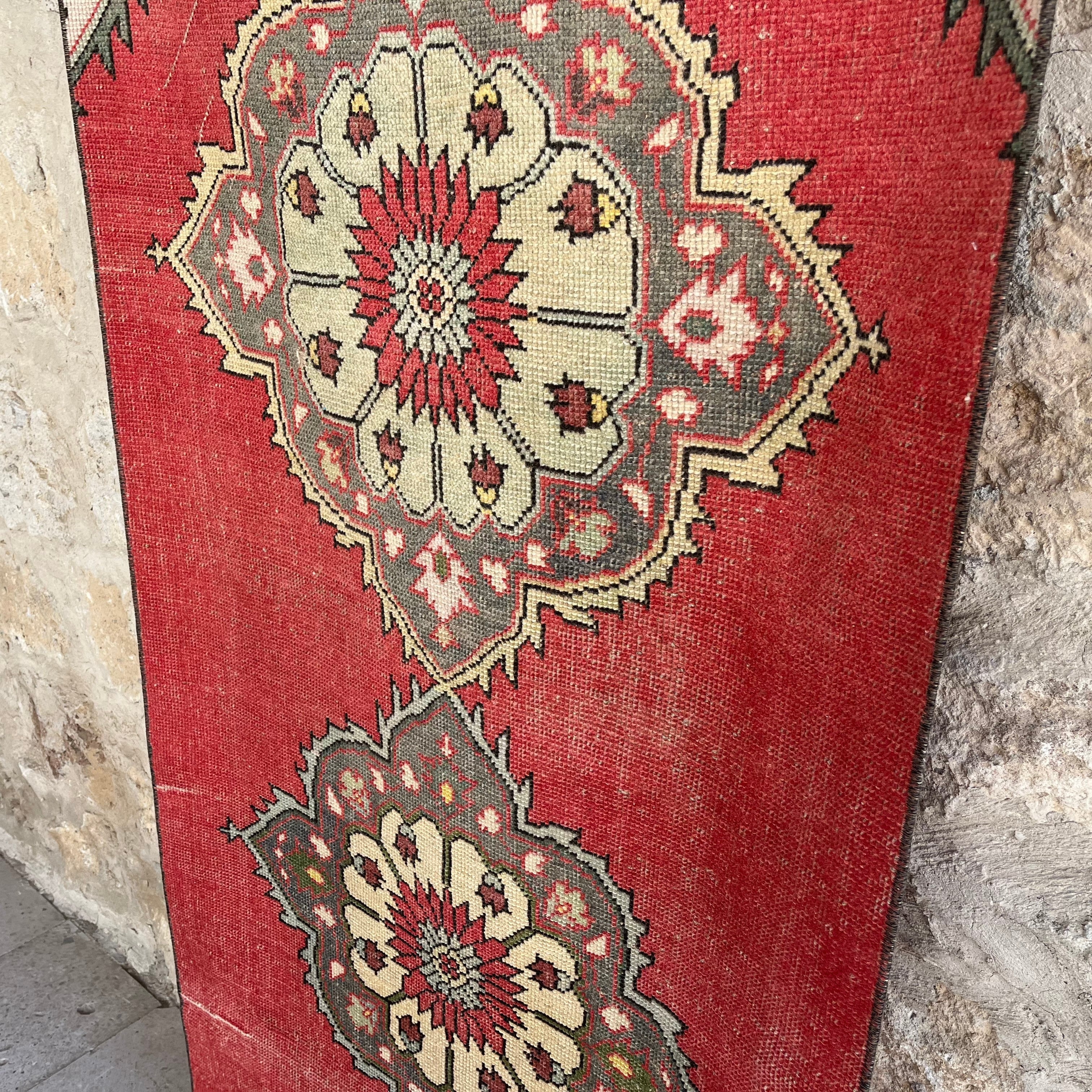 1970s red vintage turkish runner rug with traditional design, hand-knotted weave and low pile.
