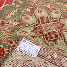 Close-up of the red vintage turkish runner rug showing geometric details, hand-knotted weave, wool and cotton and low pile.