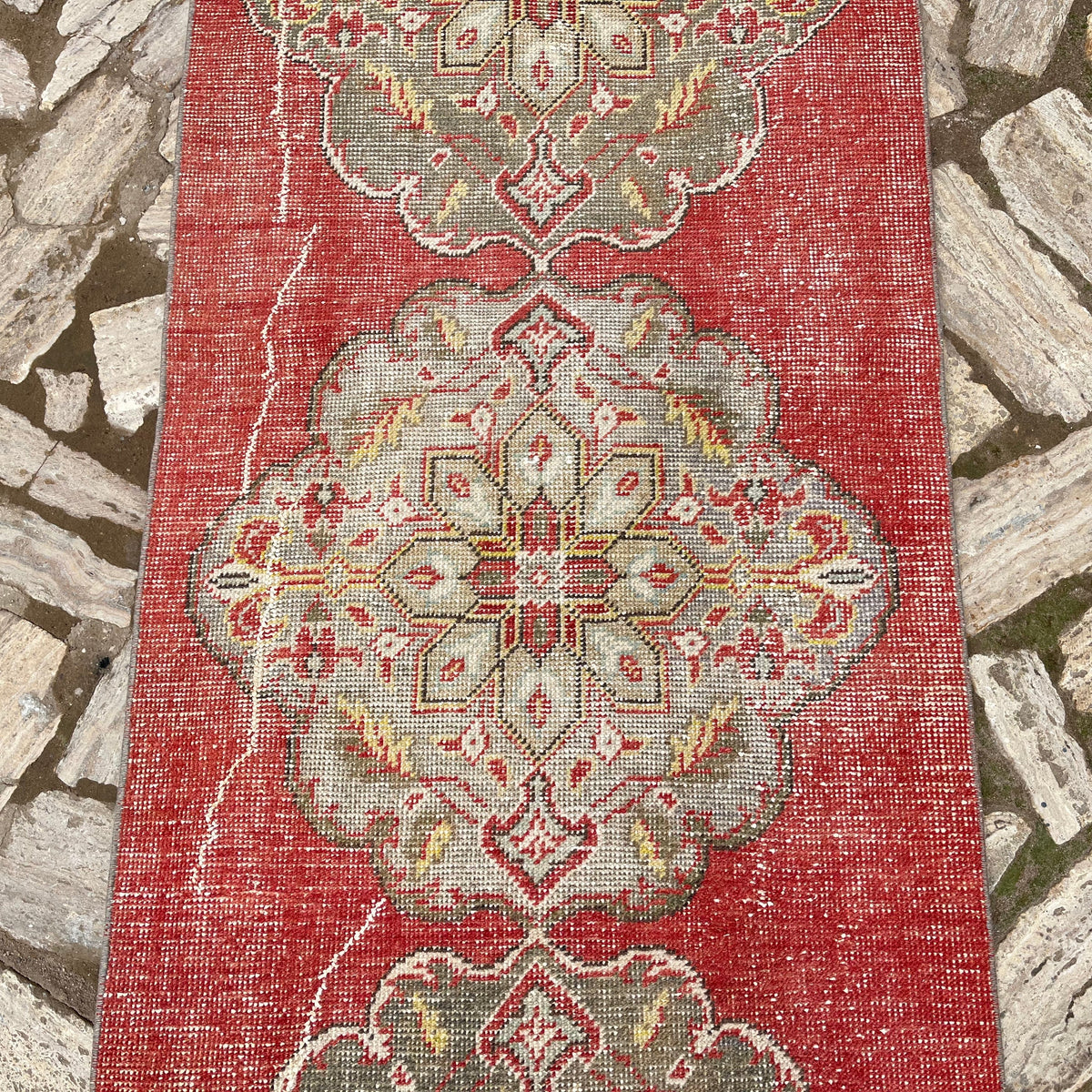 1970s red vintage turkish runner rug with geometric design, hand-knotted weave and low pile.
