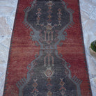 Close-up of the red vintage turkish runner rug showing traditional details, hand-knotted weave, wool and cotton and low pile.