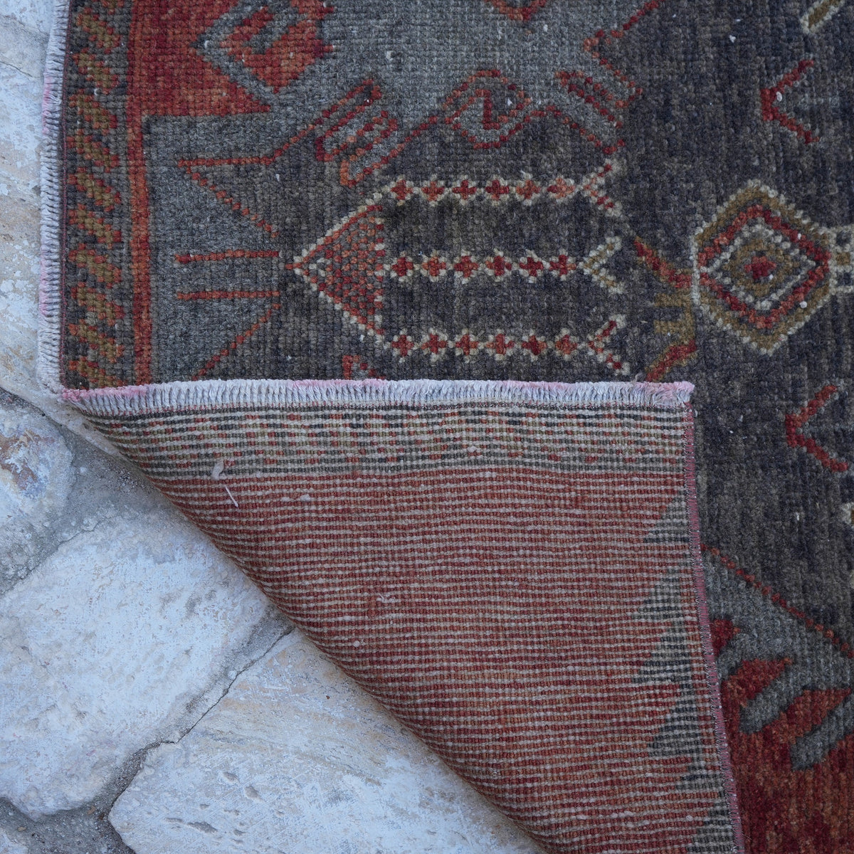 1970s red vintage turkish runner rug with traditional design, hand-knotted weave and low pile.