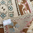 Close-up of the pale pink vintage turkish runner rug showing traditional details, hand-knotted weave, wool and cotton and low pile.